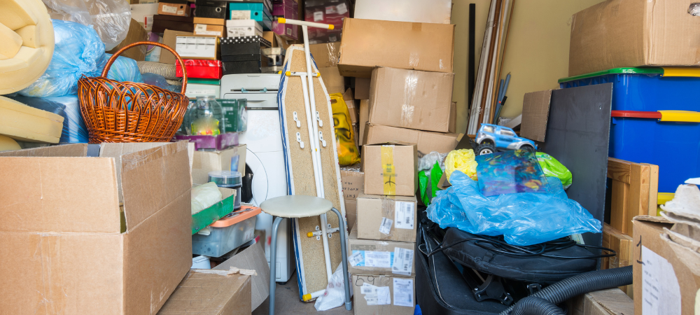 Small room with many boxes and items stacked on top of each other