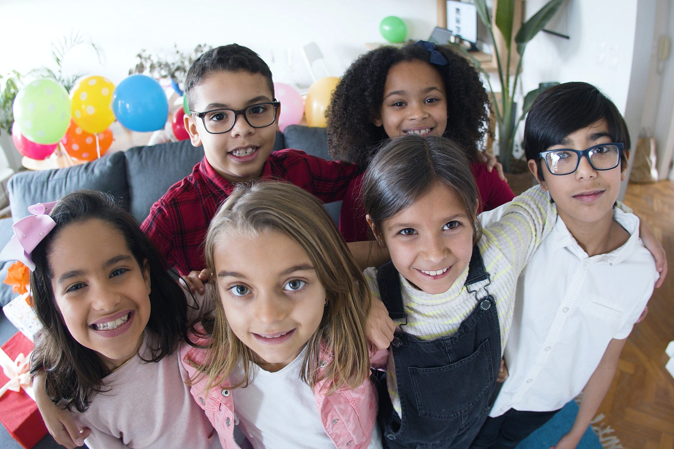 children at a party with balloons