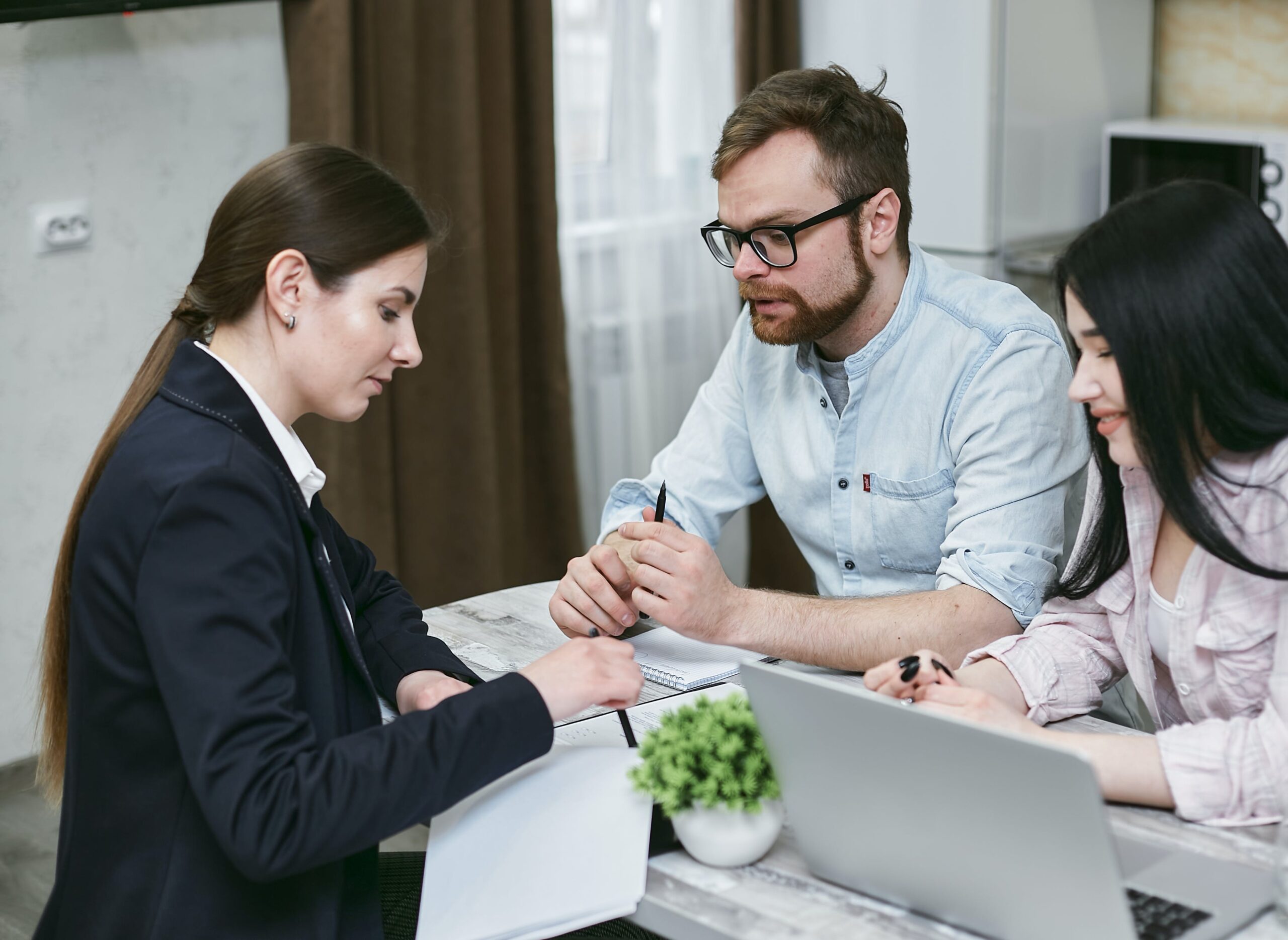 Man and woman writing legal will with lawyer