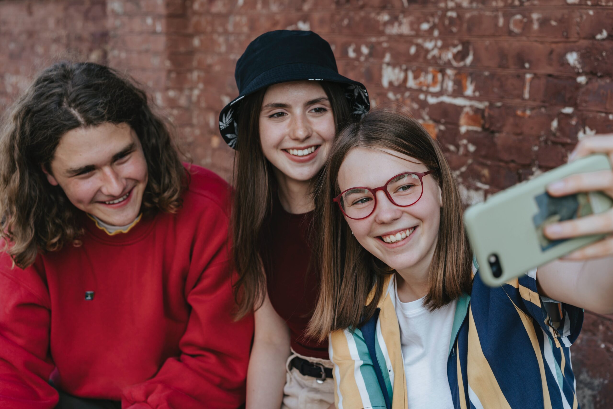 Teens taking group selfie