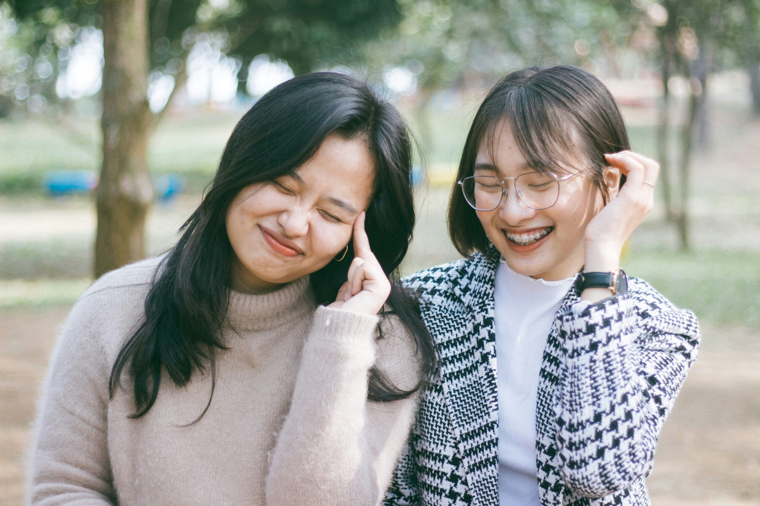 Two young women laughing together.