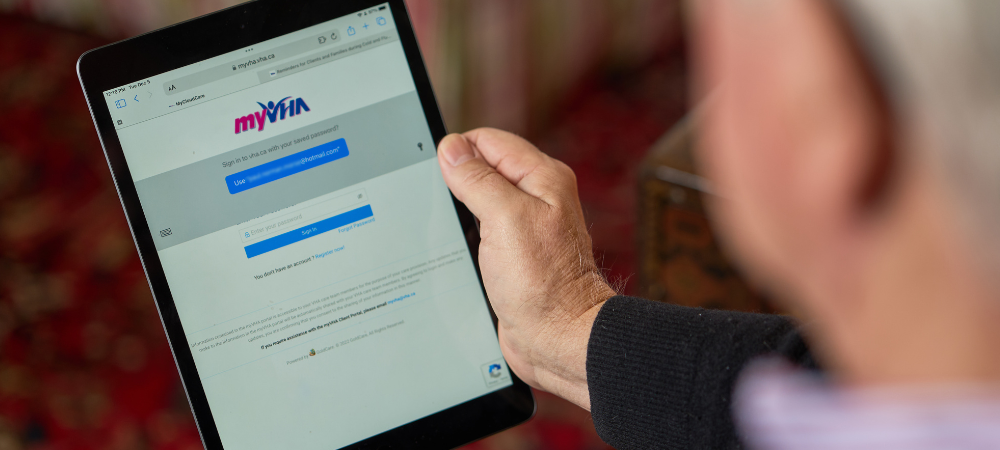 Client holds a tablet to sign into myVHA Client Portal