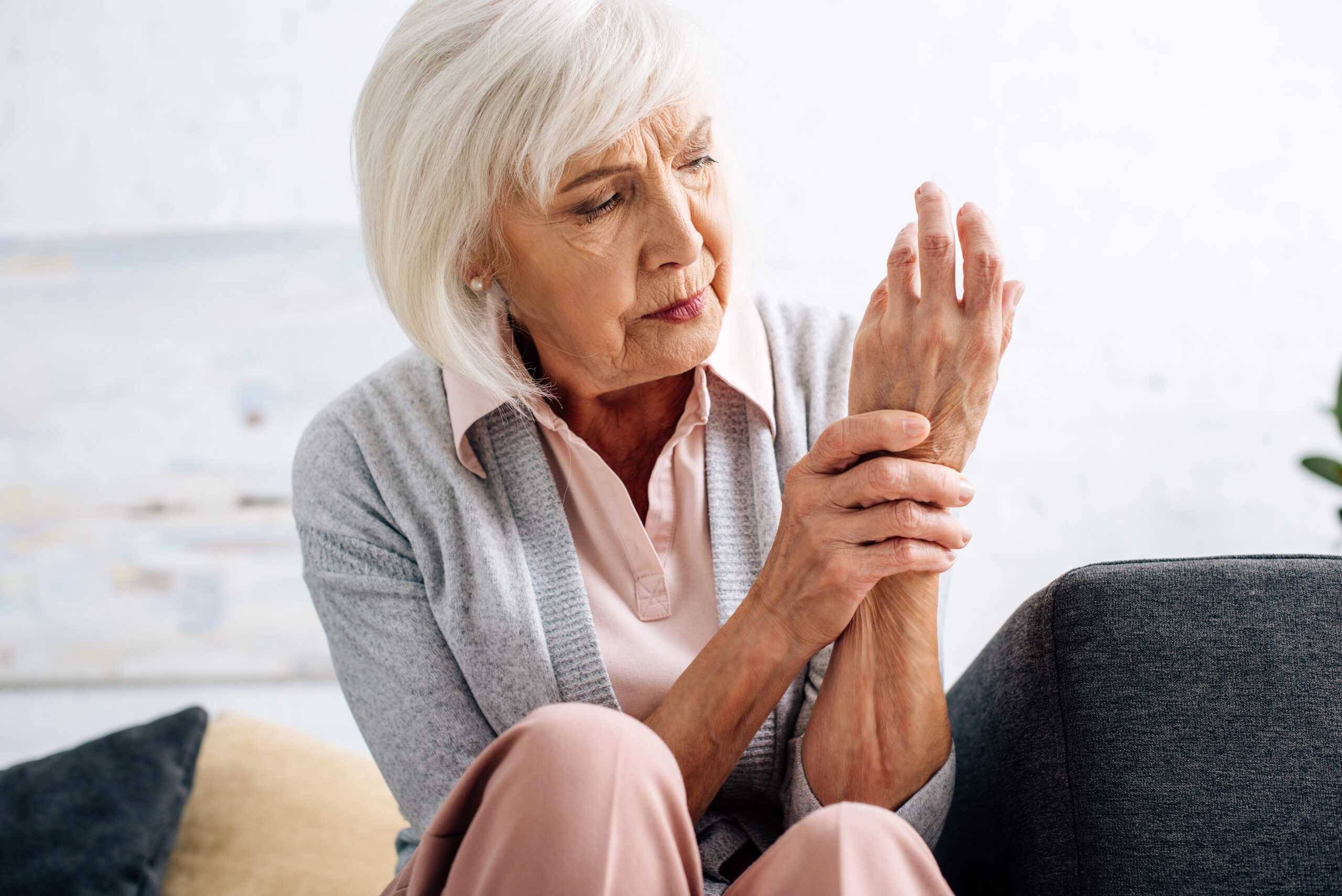 Older adult holding hand in pain