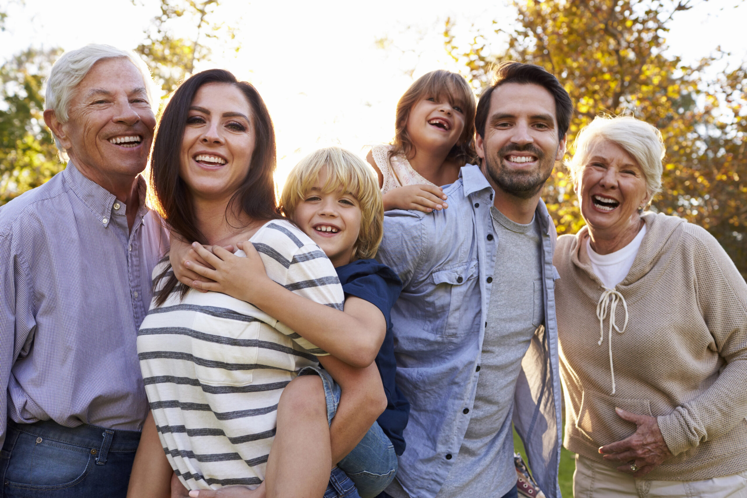 Smiling family and grandparents enjoying time together outside